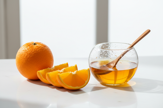 orange fruit along a transparente oil bowl